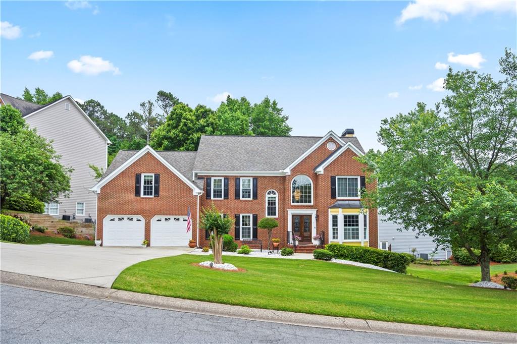 a front view of a house with a yard