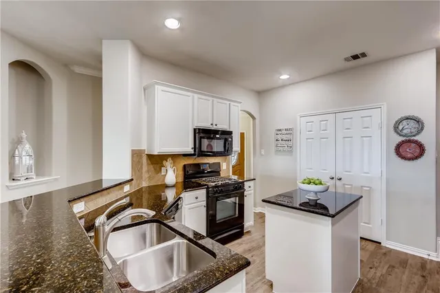 a kitchen that has a sink and a stove