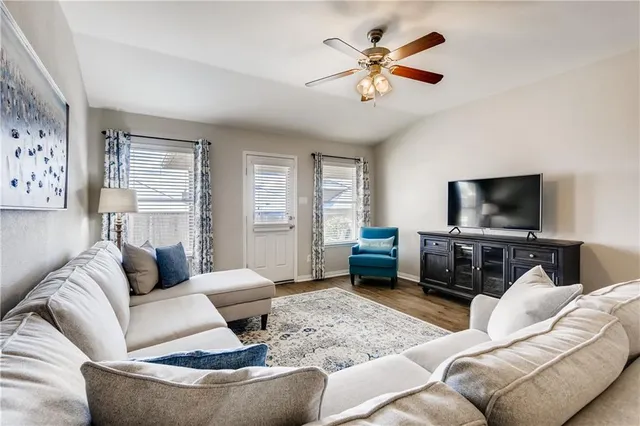 a living room with furniture and a flat screen tv