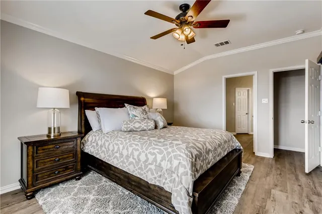 a bedroom with a bed and a chandelier