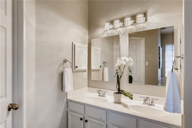 a bathroom with a sink vanity and a mirror
