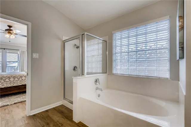 a bathroom with bathtub and a window