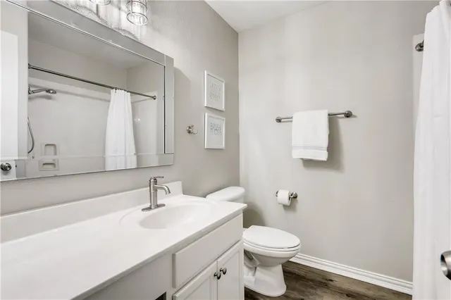 a bathroom with a sink a toilet and mirror