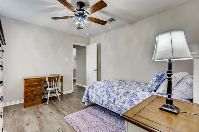a bedroom with bed and a chandelier