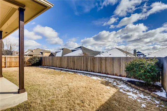 a view of a backyard of the house