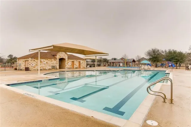 a view of swimming pool with outdoor seating and yard