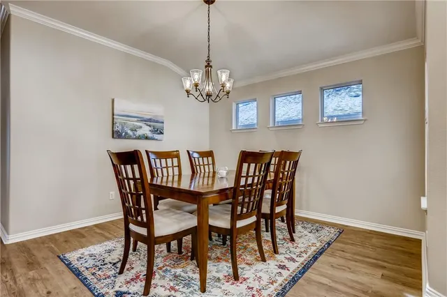 a dining room with furniture and wooden floor