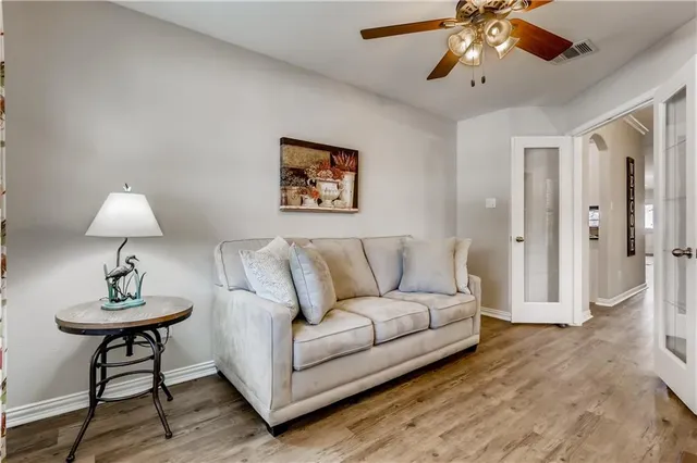 a living room with furniture and a chandelier