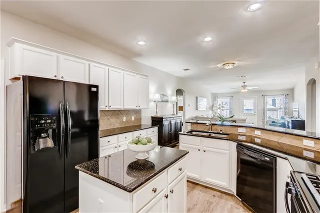 a kitchen with a sink stove and refrigerator