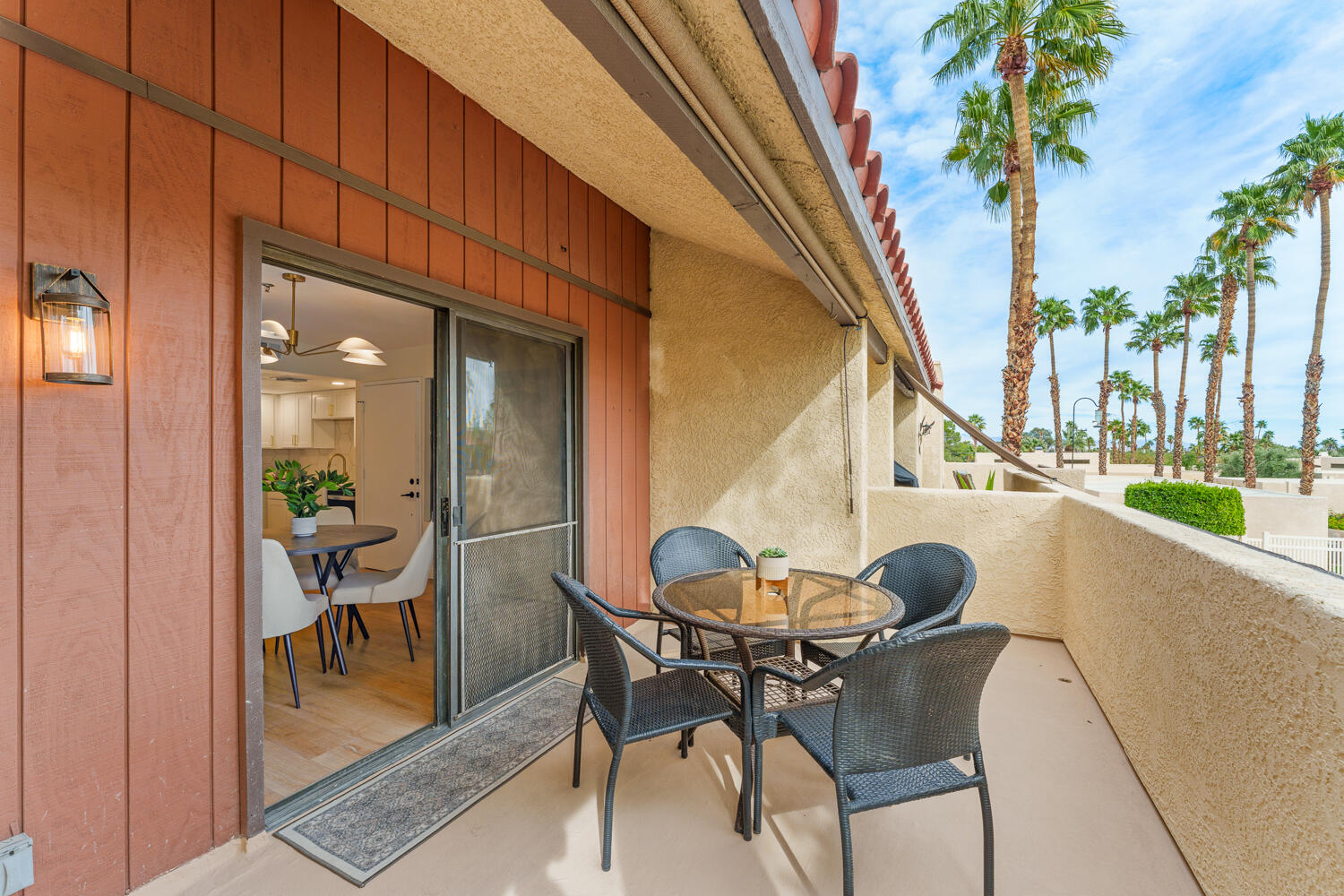 200 East Racquet Club Road, Unit 60 Palm Springs, CA 92262 - Photo 14 of 48 a view of a dining room with furniture and a potted plant