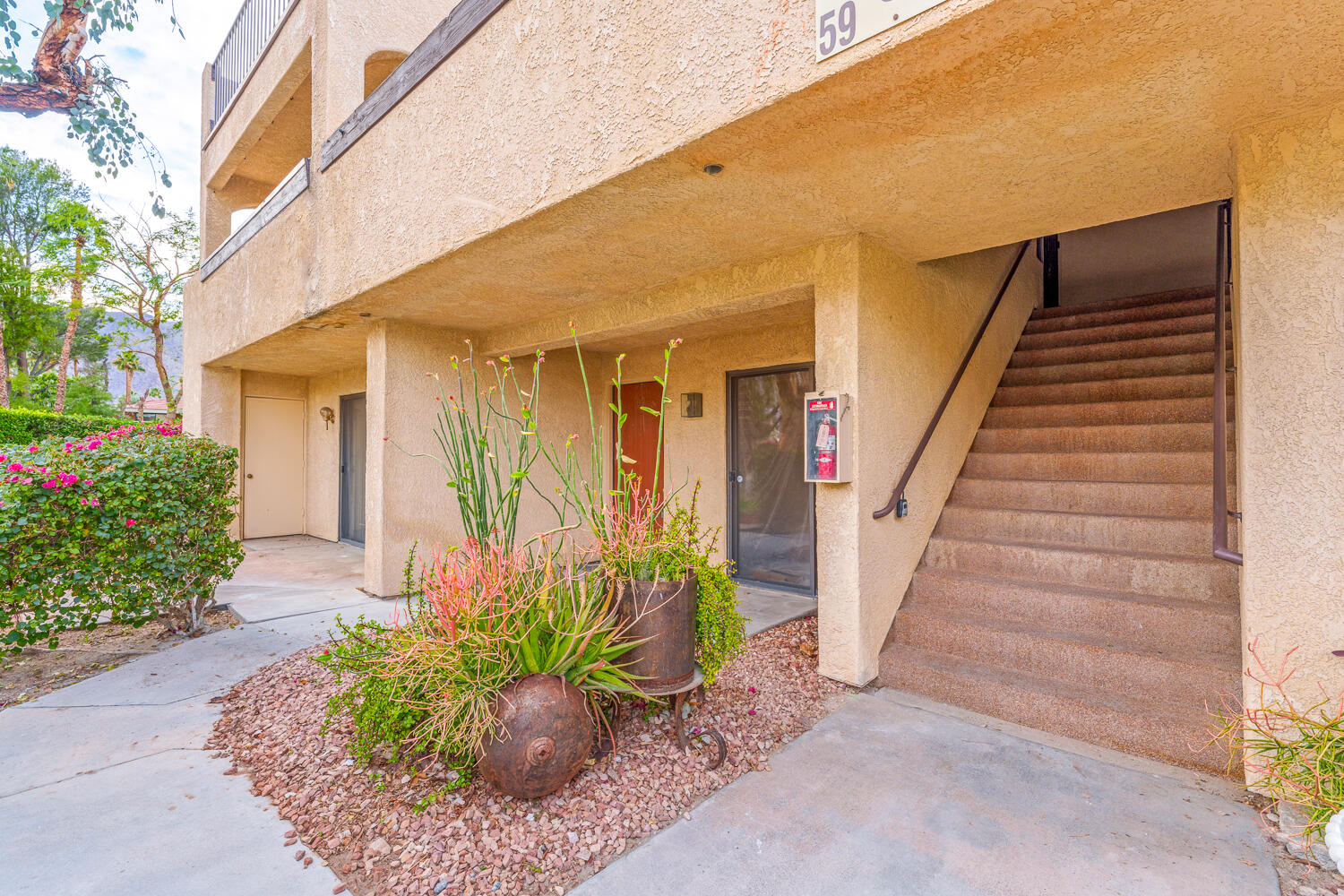 200 East Racquet Club Road, Unit 60 Palm Springs, CA 92262 - Photo 2 of 48 a view of a house with wooden floor and potted plants