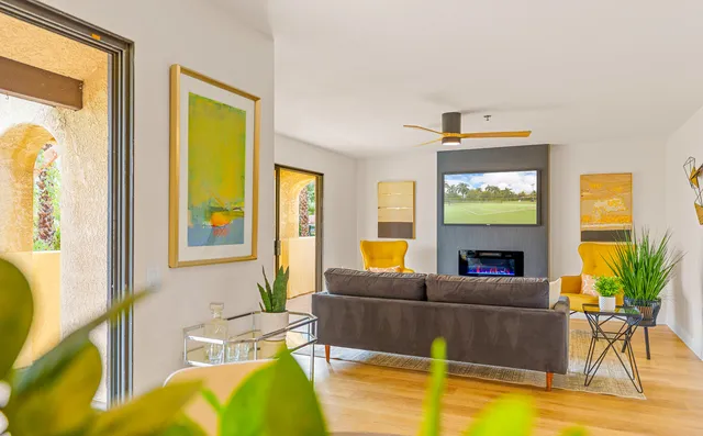 a living room with furniture a fireplace and a flat screen tv