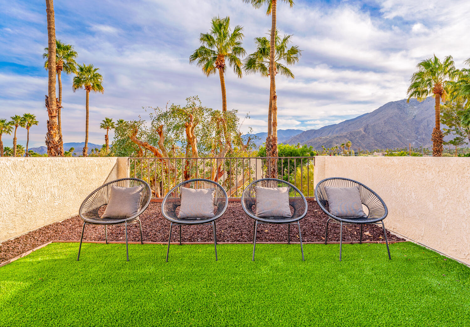 200 East Racquet Club Road, Unit 60 Palm Springs, CA 92262 - Photo 34 of 48 a couple of chairs that are sitting in the grass