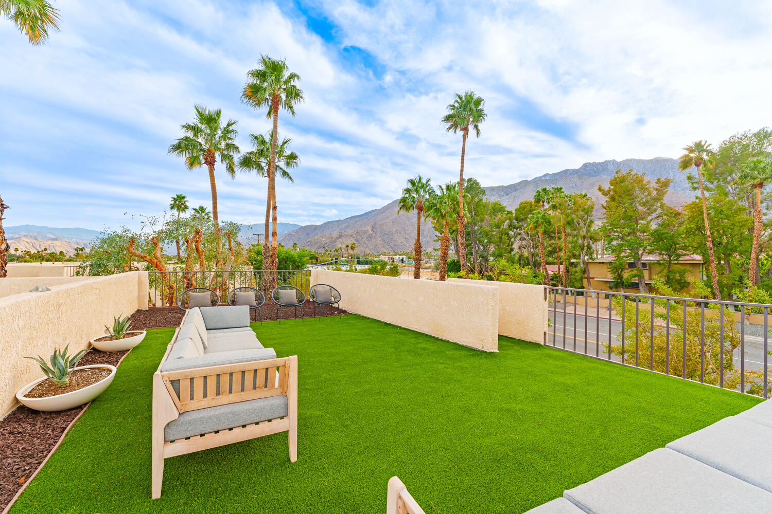 200 East Racquet Club Road, Unit 60 Palm Springs, CA 92262 - Photo 39 of 48 a view of a garden with a house in the background
