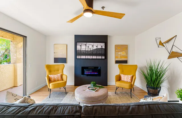 a living room with furniture and a potted plant
