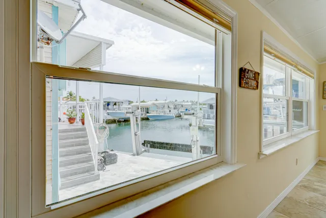 a living room with furniture two window and a table
