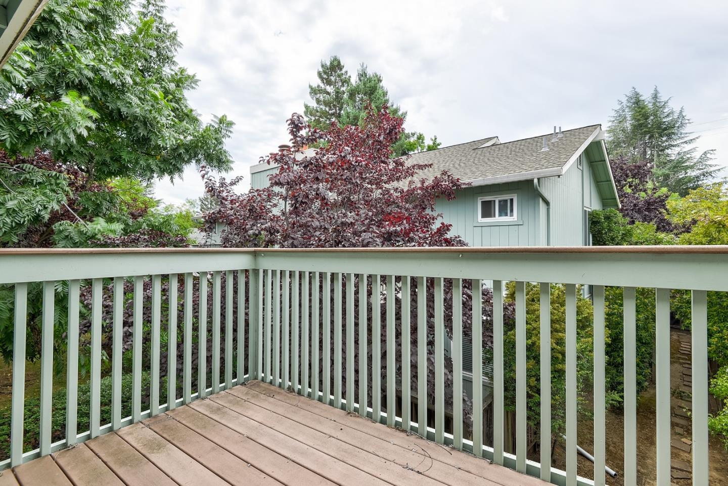 950 Boranda Avenue, Unit 10 Mountain View, CA 94040 - Photo 18 of 20 a balcony with wooden floor and fence