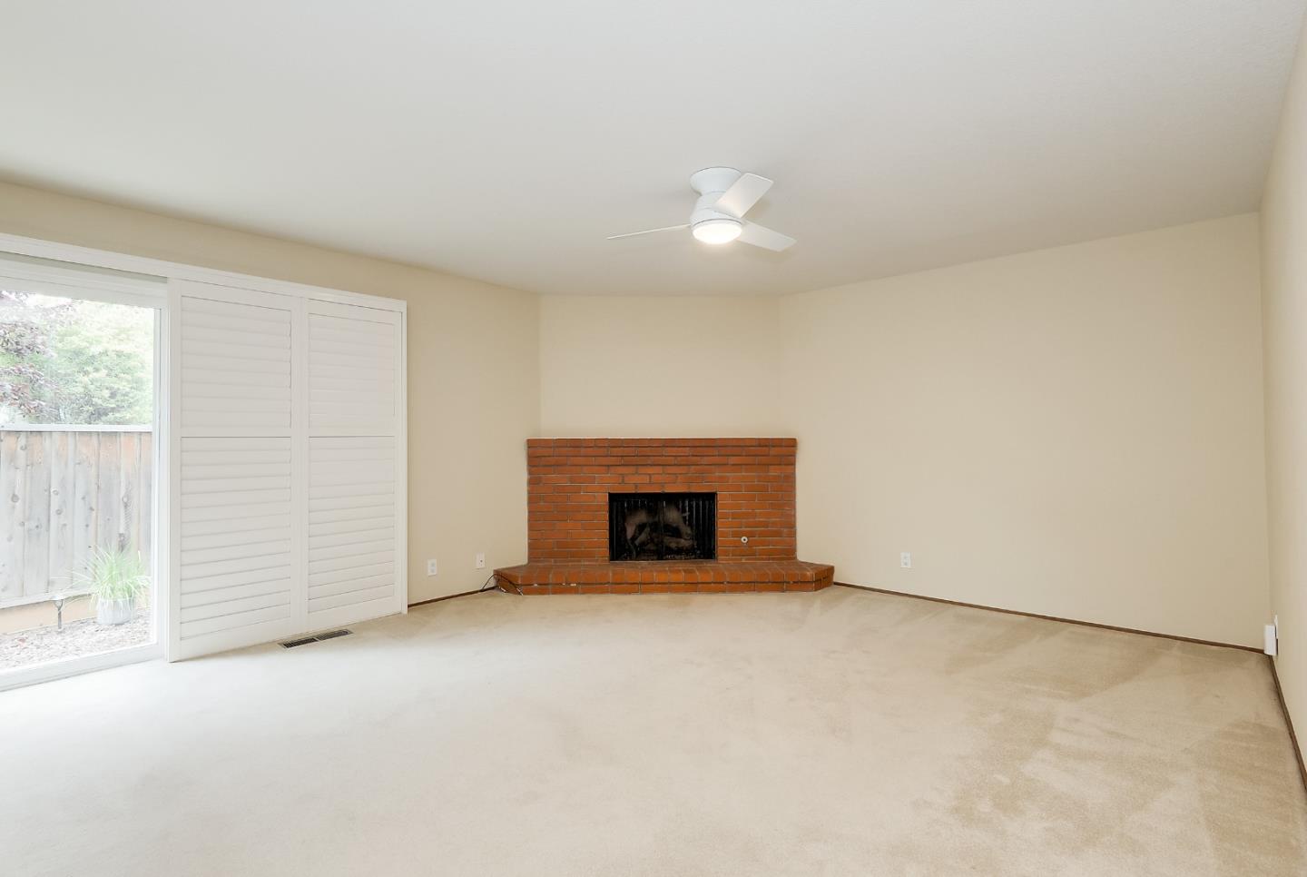 950 Boranda Avenue, Unit 10 Mountain View, CA 94040 - Photo 3 of 20 an empty room with a fireplace and window