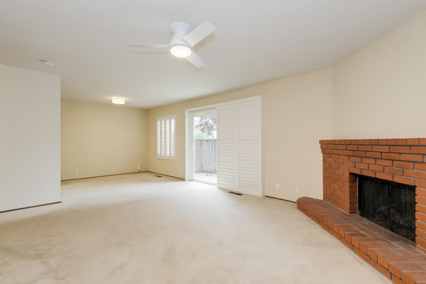 950 Boranda Avenue, Unit 10 Mountain View, CA 94040 - Photo 4 of 20 an empty room with windows and fireplace