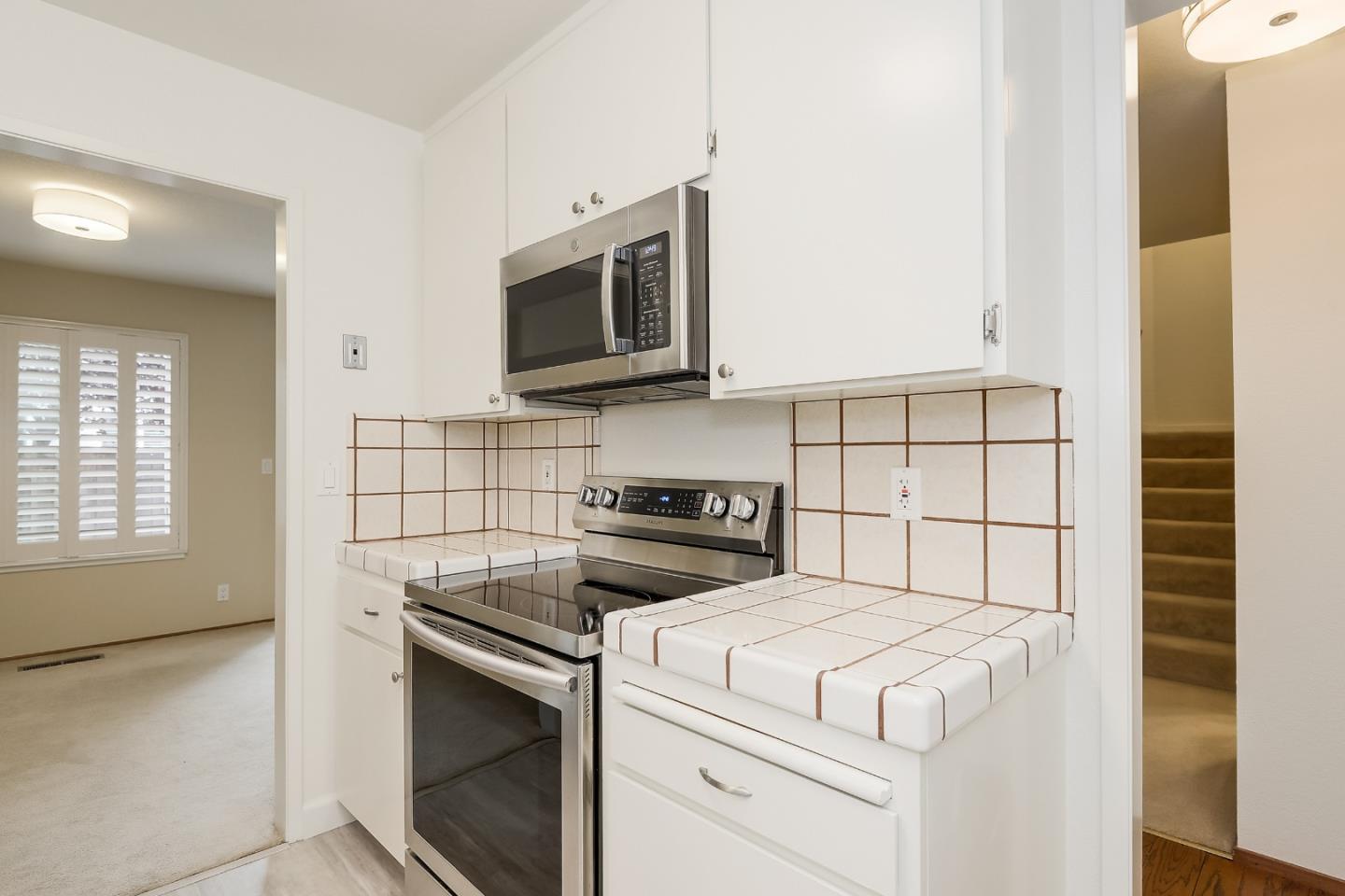 950 Boranda Avenue, Unit 10 Mountain View, CA 94040 - Photo 6 of 20 a kitchen with a stove and a microwave