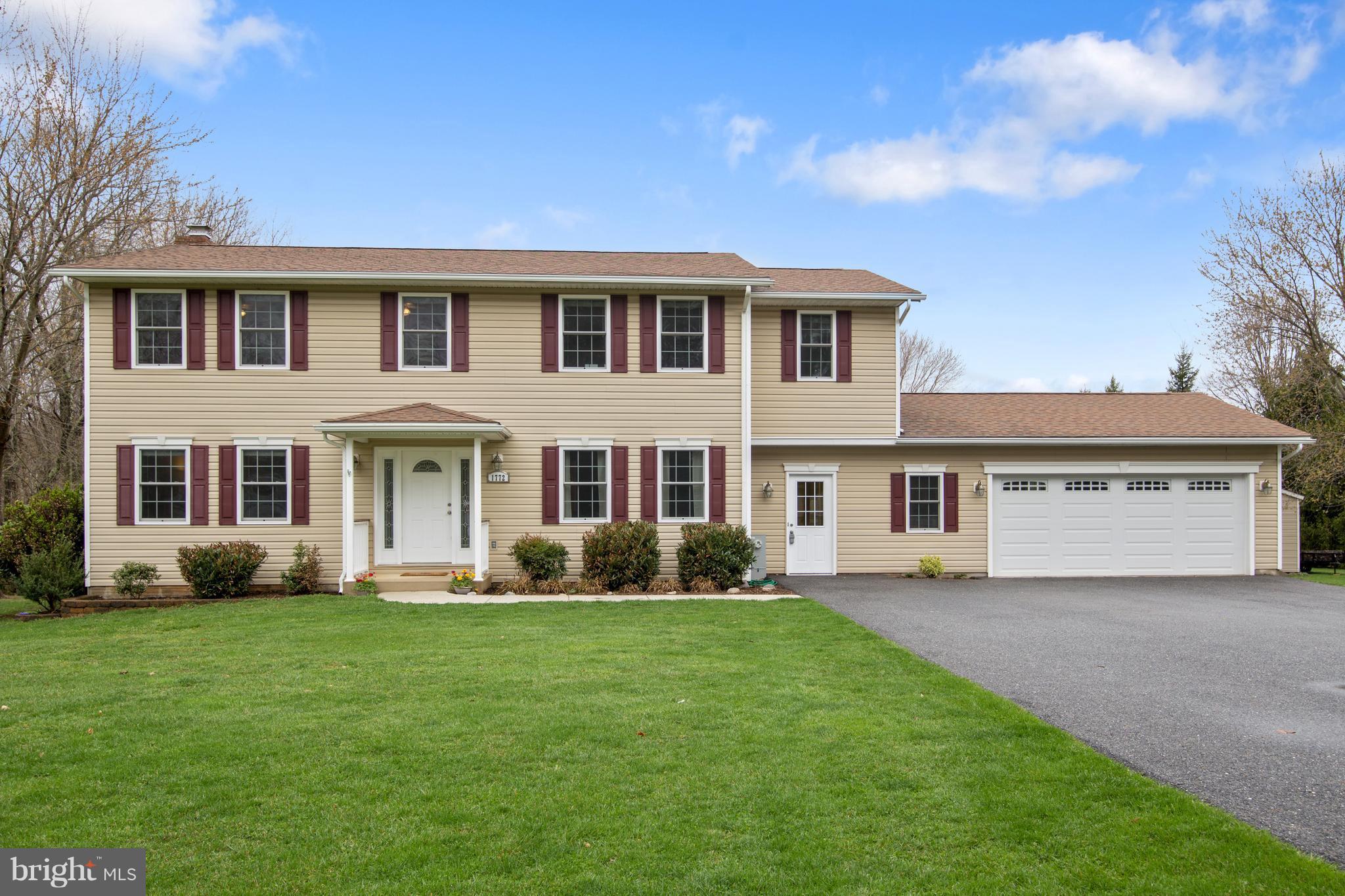 a front view of a house with garden and porch