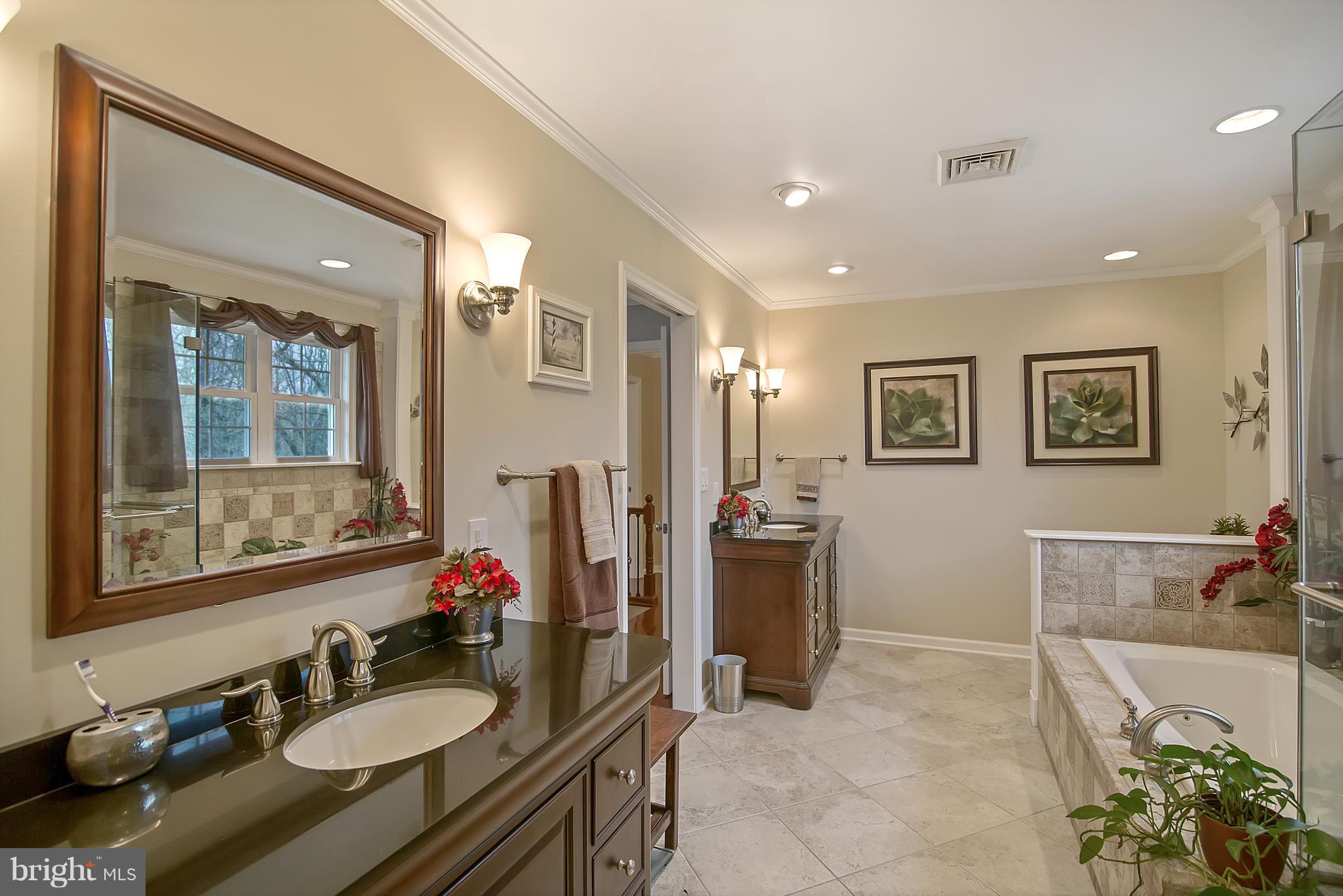 1772 Bloom Road Westminster, MD 21157 - Photo 11 of 30 a bathroom with a sink double vanity granite tub shower and a mirror