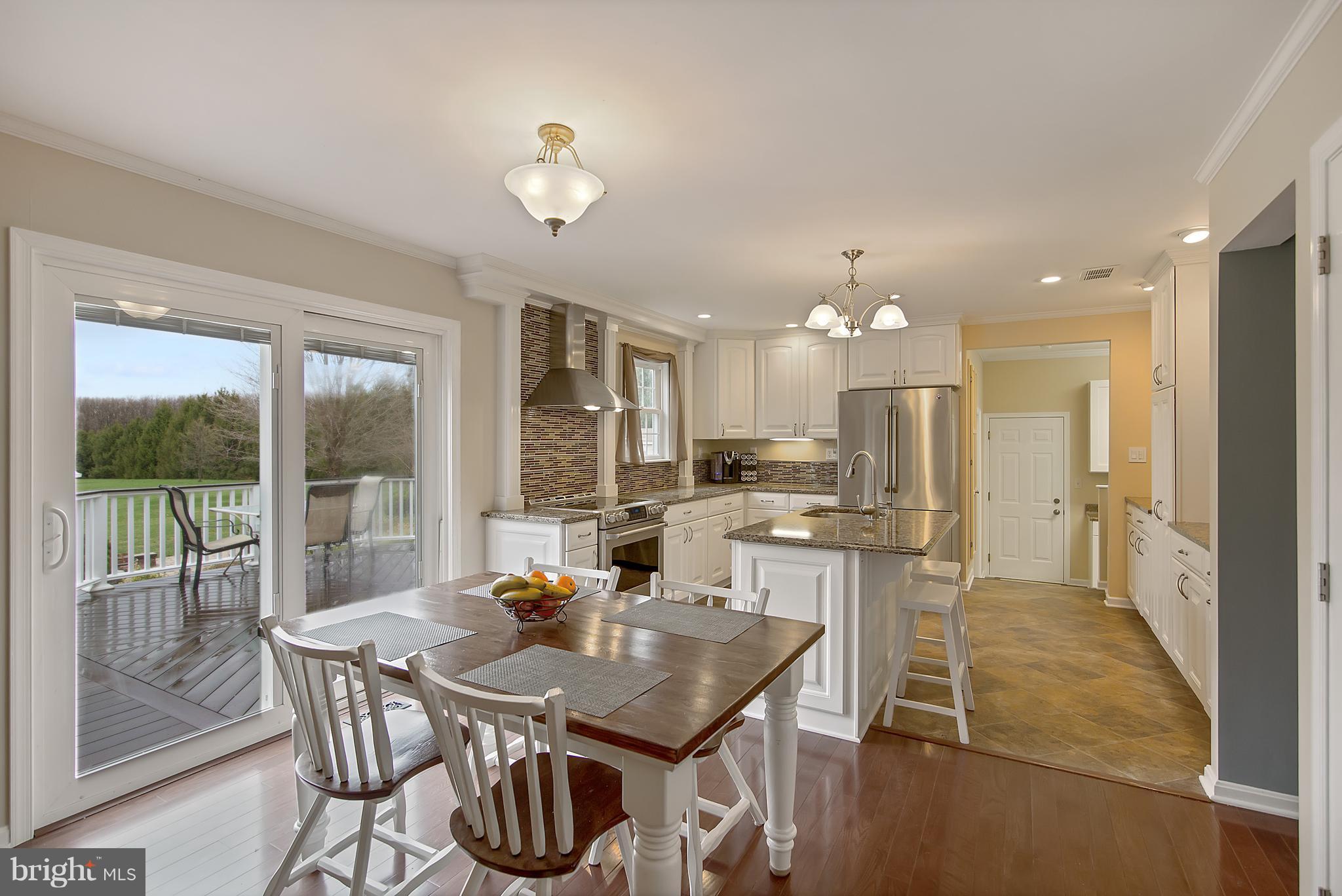 1772 Bloom Road Westminster, MD 21157 - Photo 6 of 30 a view of a dining room with furniture large windows and wooden floor