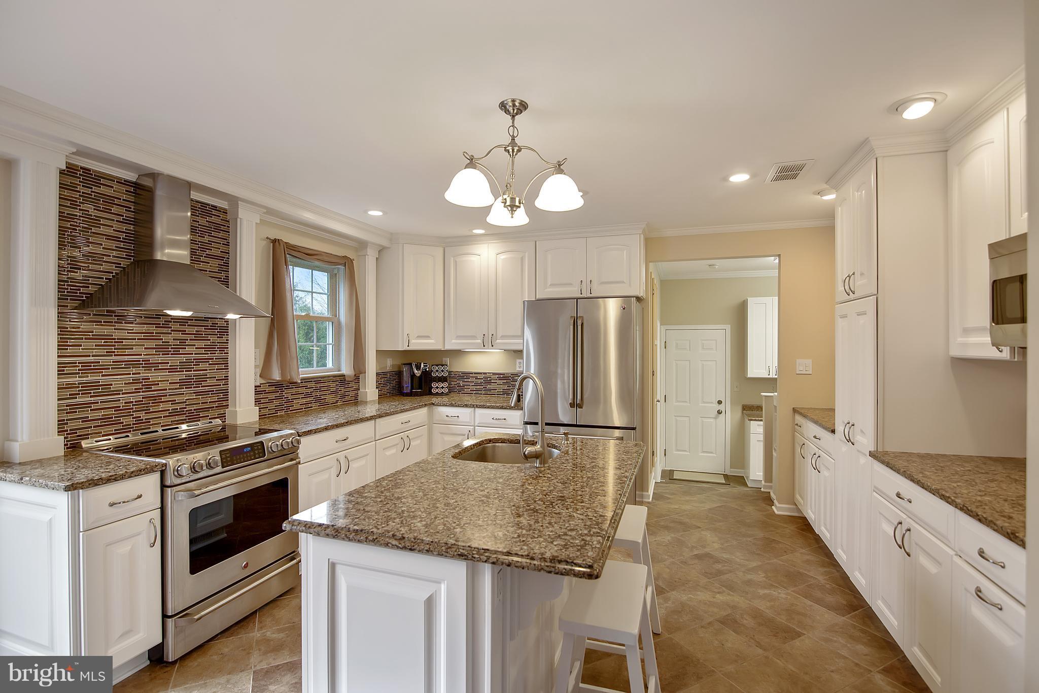 1772 Bloom Road Westminster, MD 21157 - Photo 7 of 30 a kitchen with stainless steel appliances granite countertop a stove refrigerator and cabinets