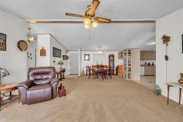 a kitchen with kitchen island granite countertop a stove a sink a refrigerator and cabinets