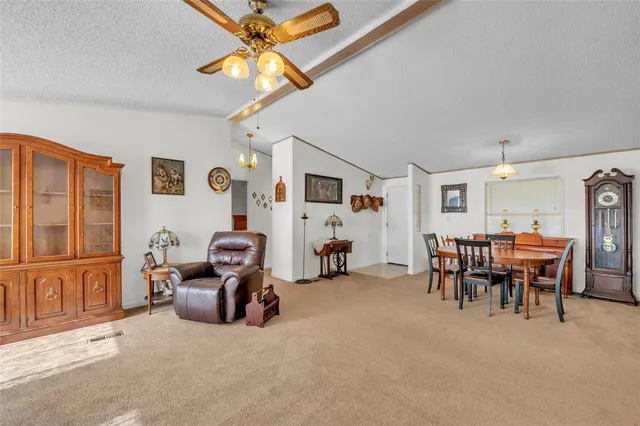 a kitchen with granite countertop a sink and white cabinets