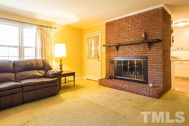 2709 Baptist Road Durham, NC 27703 - Photo 16 of 25 a living room with furniture windows and a fireplace