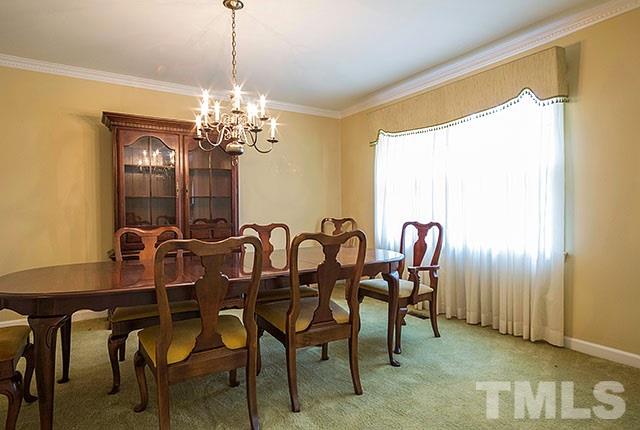 2709 Baptist Road Durham, NC 27703 - Photo 7 of 25 a view of a dining room with furniture and a chandelier