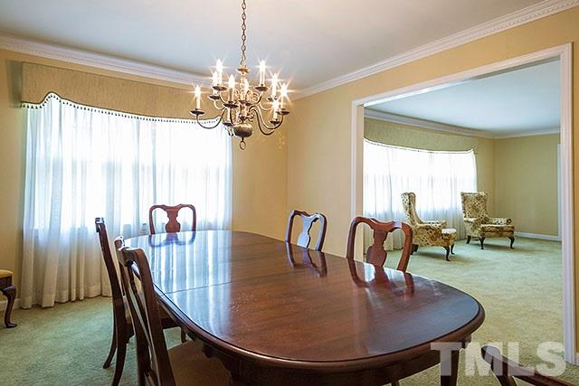 2709 Baptist Road Durham, NC 27703 - Photo 8 of 25 a dining room with furniture a chandelier and window