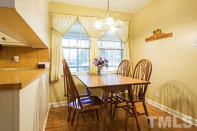 2709 Baptist Road Durham, NC 27703 - Photo 9 of 25 a view of a dining room with furniture and a chandelier