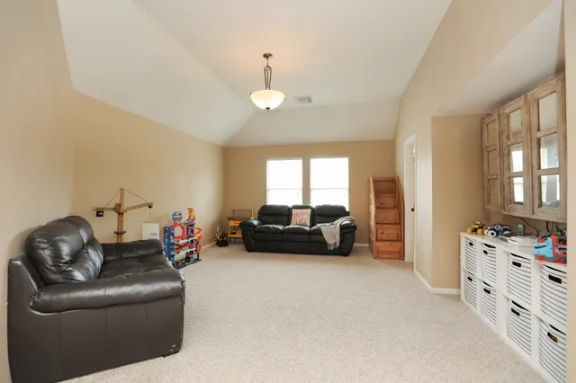 a bedroom with furniture and a window