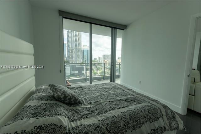 92 Southwest 3rd Street, Unit 1802 Miami, FL 33130 - Photo 8 of 19 a bed sitting in a bedroom next to a window