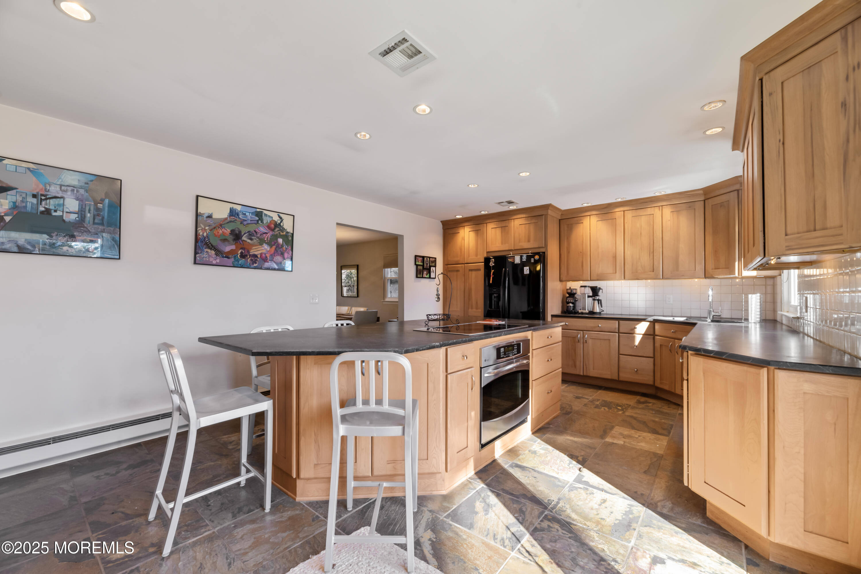 35 Rues Road Cream Ridge, NJ 08514 - Photo 28 of 46 a kitchen with stainless steel appliances granite countertop a stove top oven a sink a dining table and chairs with wooden floor