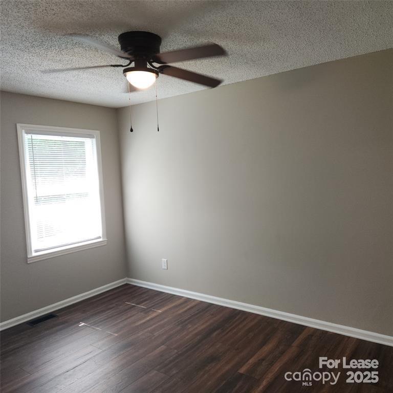 2177 Lynmore Drive Sherrills Ford, NC 28673 - Photo 11 of 18 an empty room with wooden floor ceiling fan and window