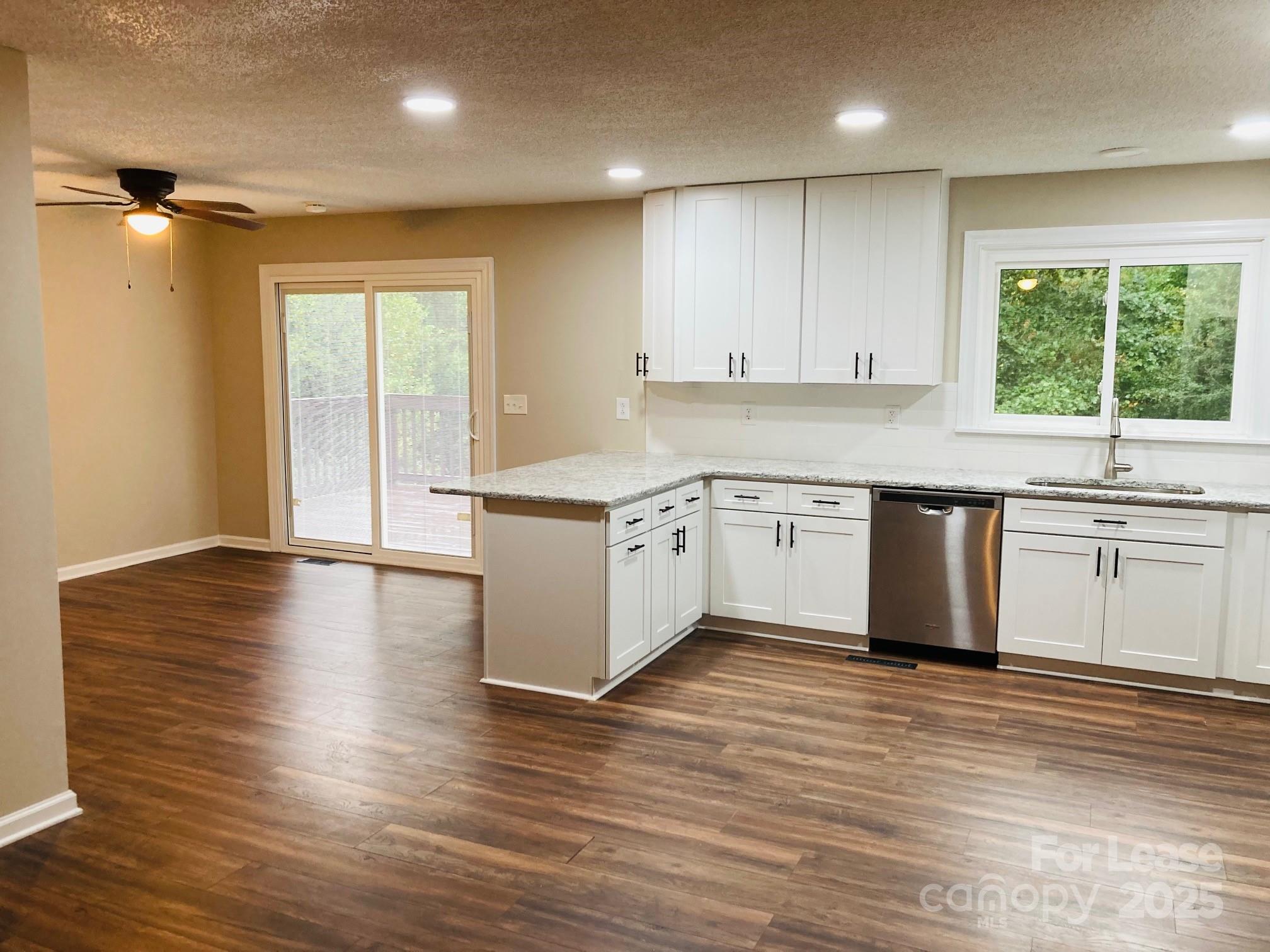 2177 Lynmore Drive Sherrills Ford, NC 28673 - Photo 5 of 18 a kitchen with wooden floors and white appliances