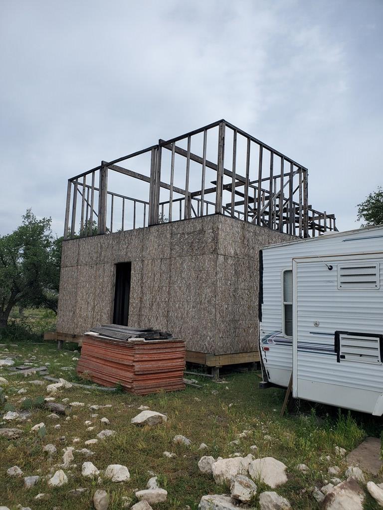 970 Cave Wells Road, Unit 29 Fort McKavett, TX 76841 - Photo 2 of 4 a view of a house with a yard