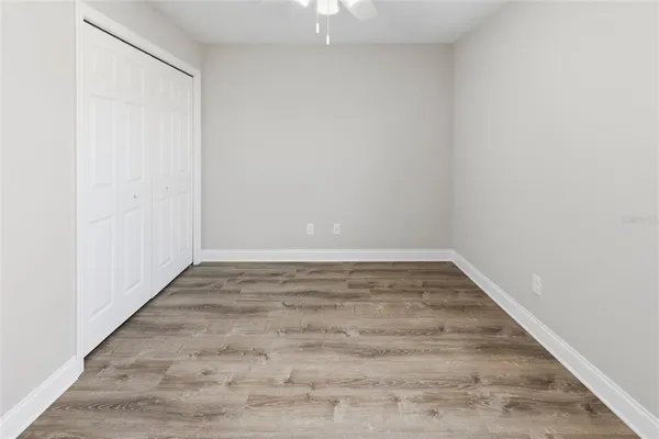 a view of an empty room with wooden floor