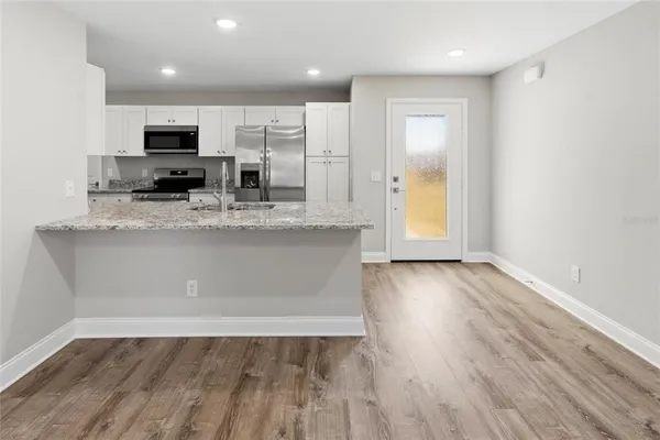 a view of a kitchen with a sink and microwave
