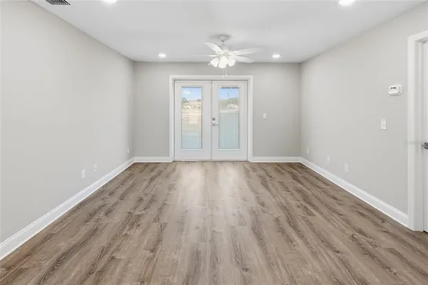 wooden floor in an empty room with a window