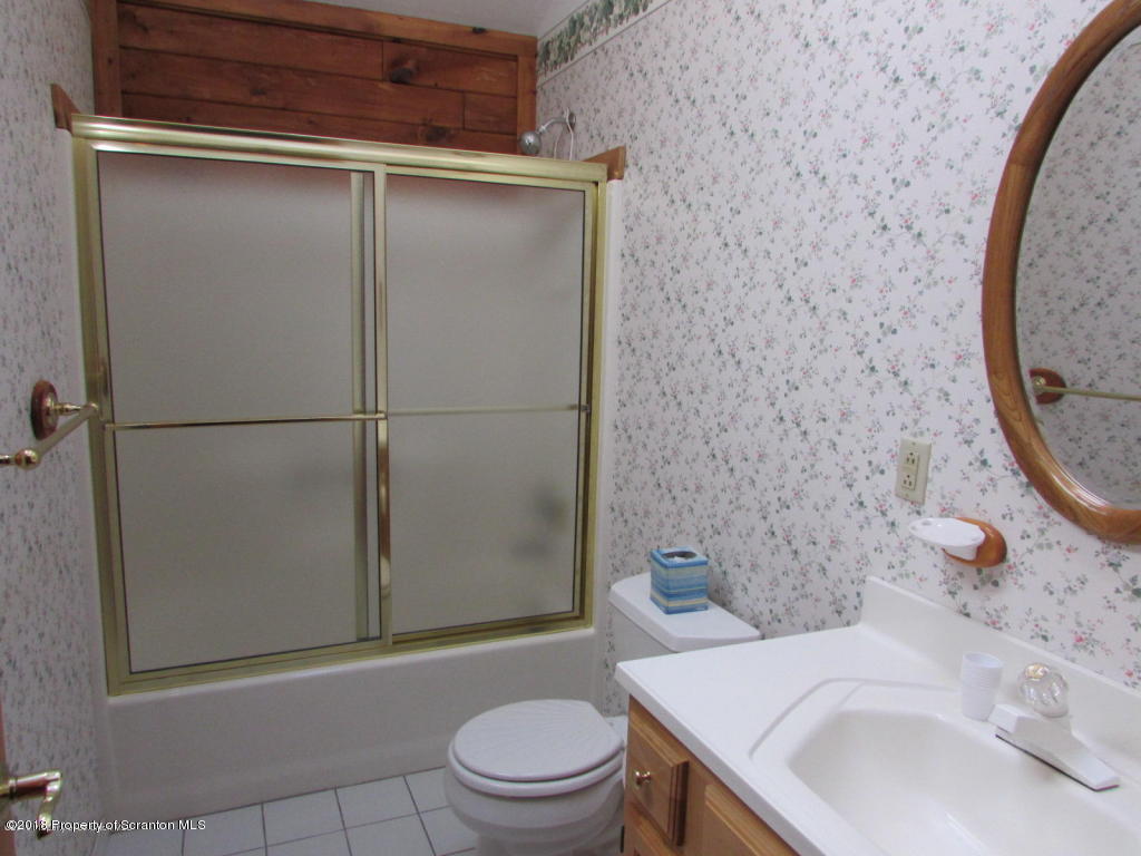11068 State Rte 3023 Montrose, PA 18801 - Photo 13 of 38 a bathroom with a sink a toilet and shower