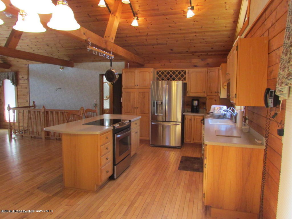 11068 State Rte 3023 Montrose, PA 18801 - Photo 3 of 38 a kitchen with stainless steel appliances granite countertop a refrigerator a stove and a wooden floors