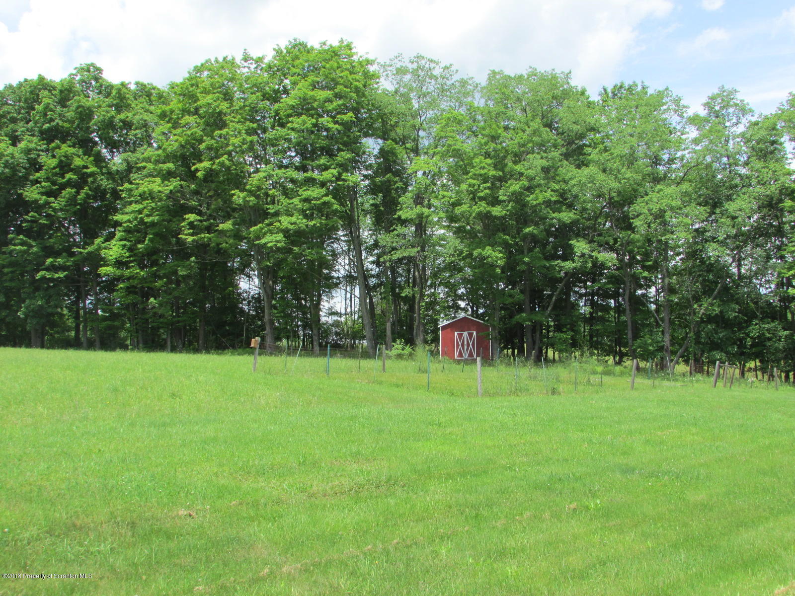 11068 State Rte 3023 Montrose, PA 18801 - Photo 33 of 38 a backyard of a house with lots of green space and trampoline