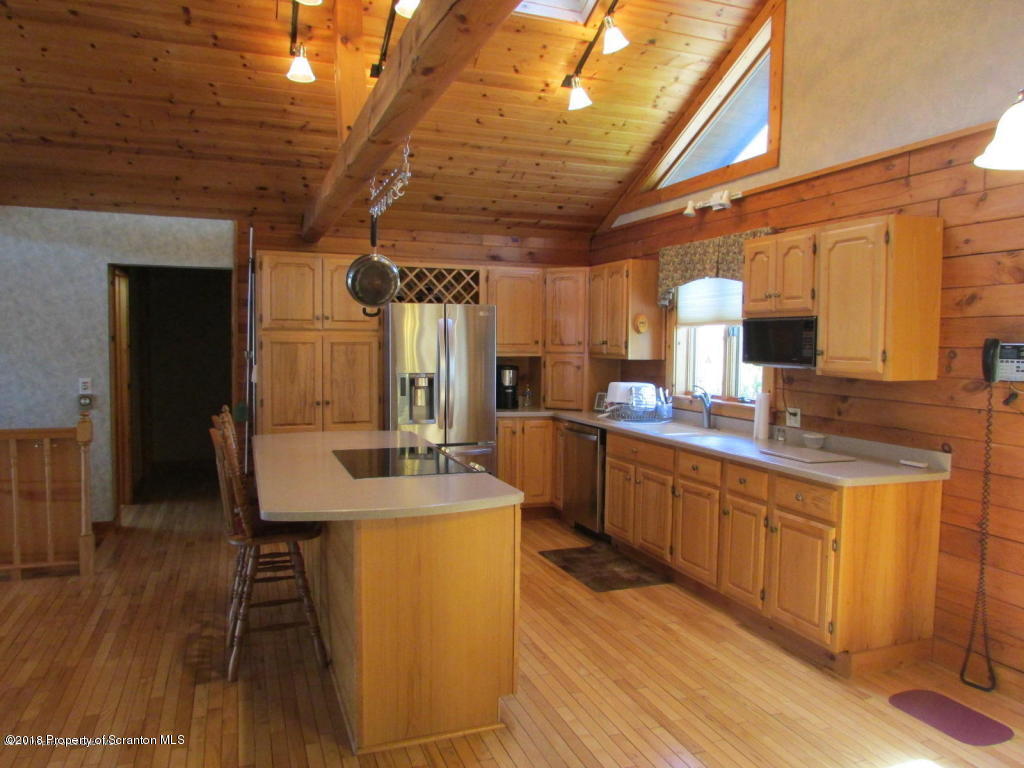 11068 State Rte 3023 Montrose, PA 18801 - Photo 4 of 38 a kitchen with sink cabinets and wooden floor