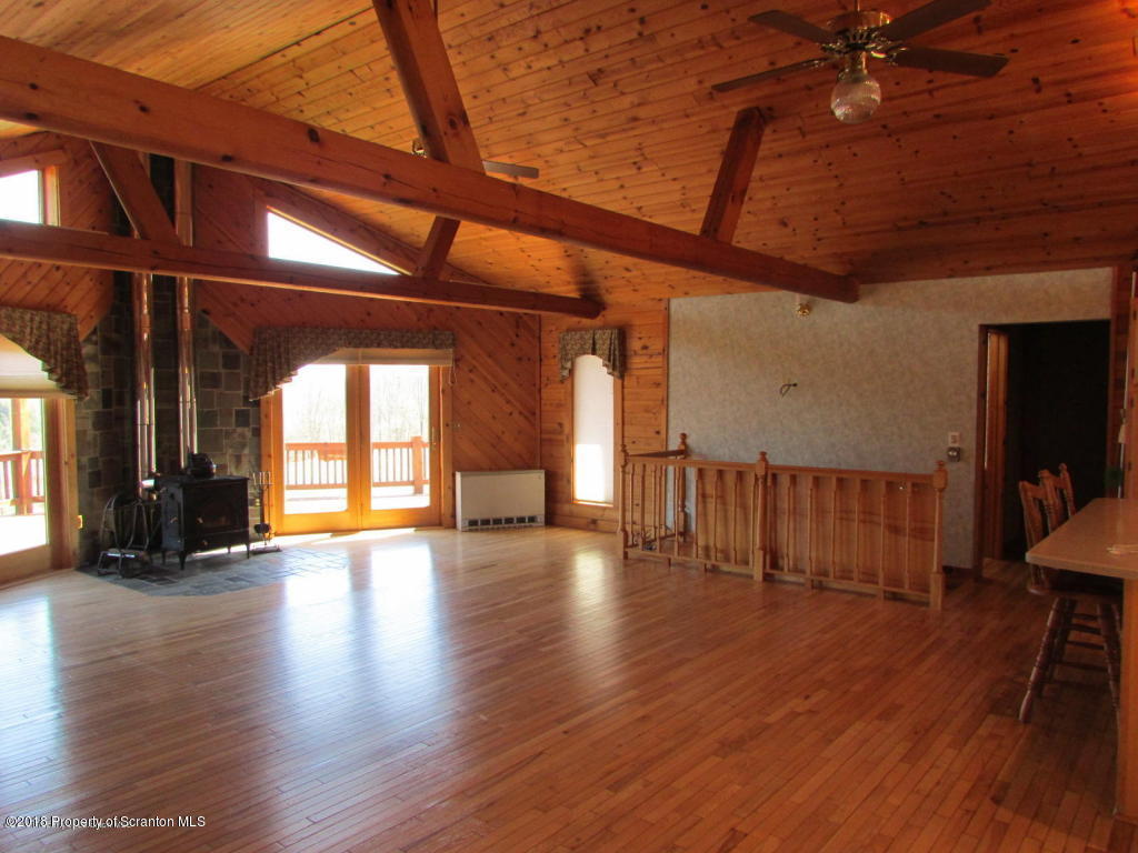 11068 State Rte 3023 Montrose, PA 18801 - Photo 8 of 38 a view of an empty room with wooden floor and a window