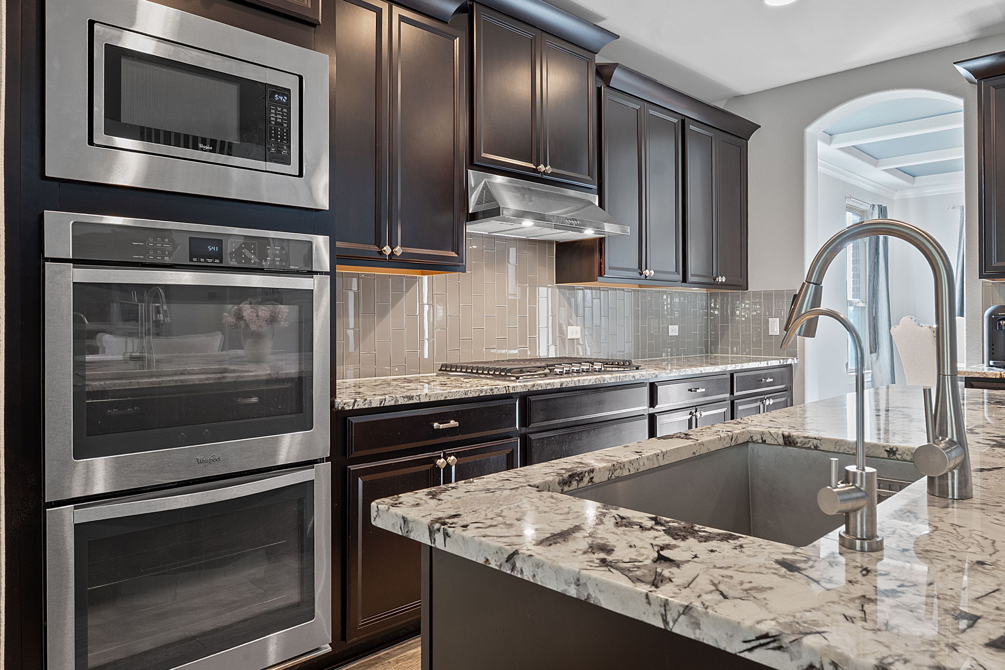 4212 Borho Ranch Street Leander, TX 78641 - Photo 11 of 37 Kitchen featuring stainless steel appliances, light stone counters, and decorative backsplash
