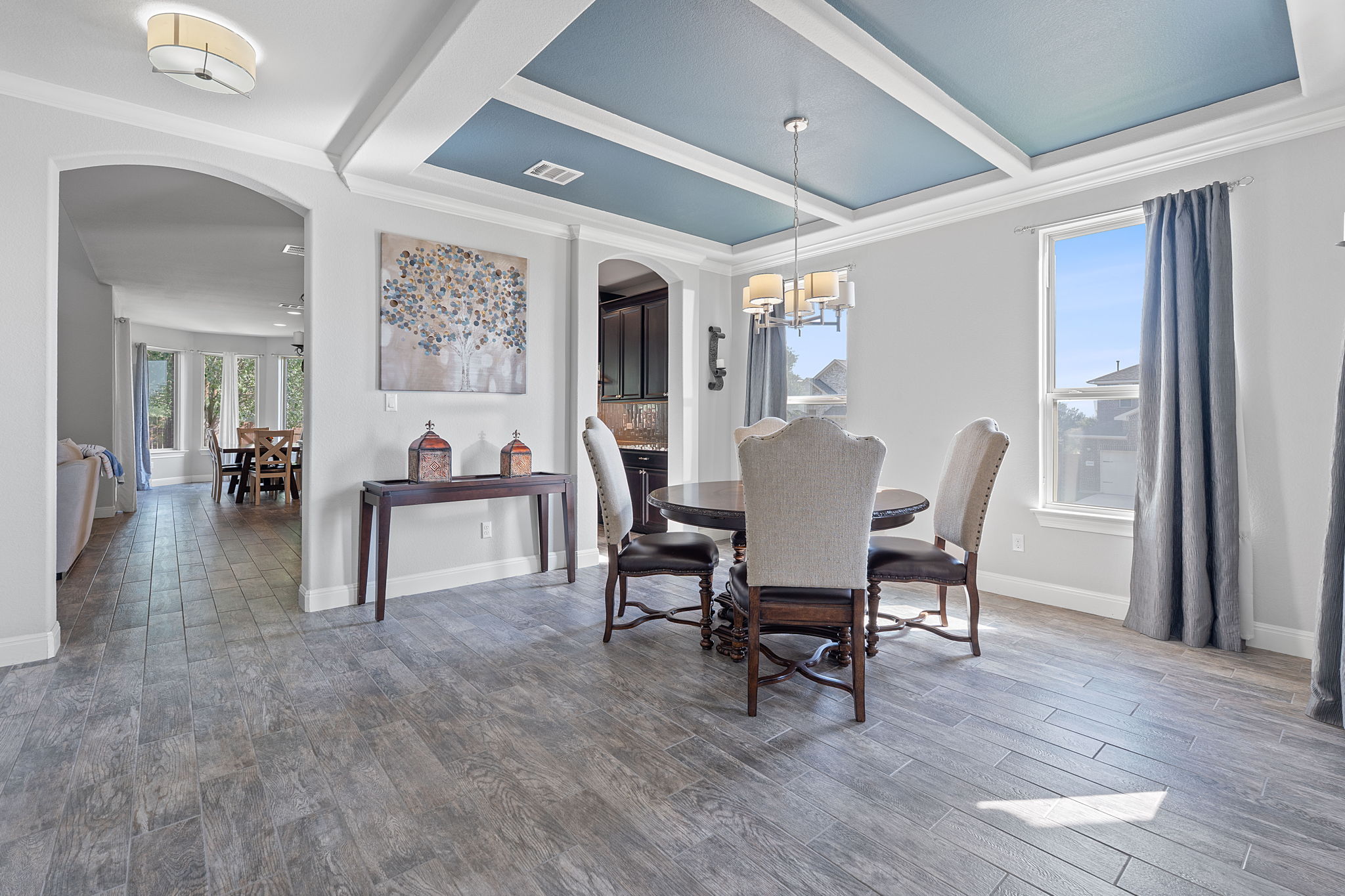 4212 Borho Ranch Street Leander, TX 78641 - Photo 12 of 37 Dining space with arched walkways, a chandelier, ornamental molding, wood finished floors, and beam ceiling